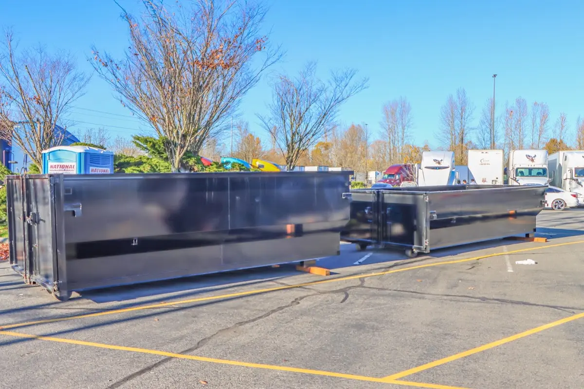 Professional dumpster rental service with roll-off container on residential driveway in Clearfield